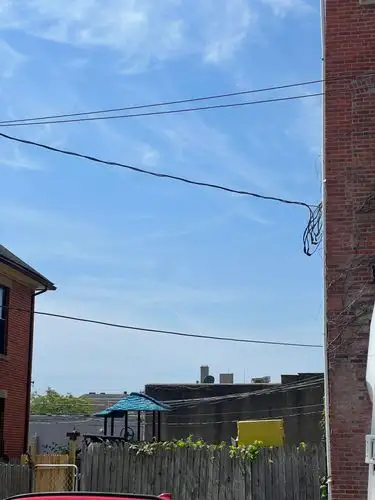 Wires, bricks, and a brilliant blue city sky.